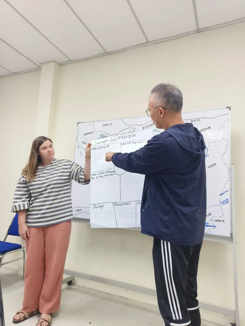 Pastor Jony teaching at a whiteboard